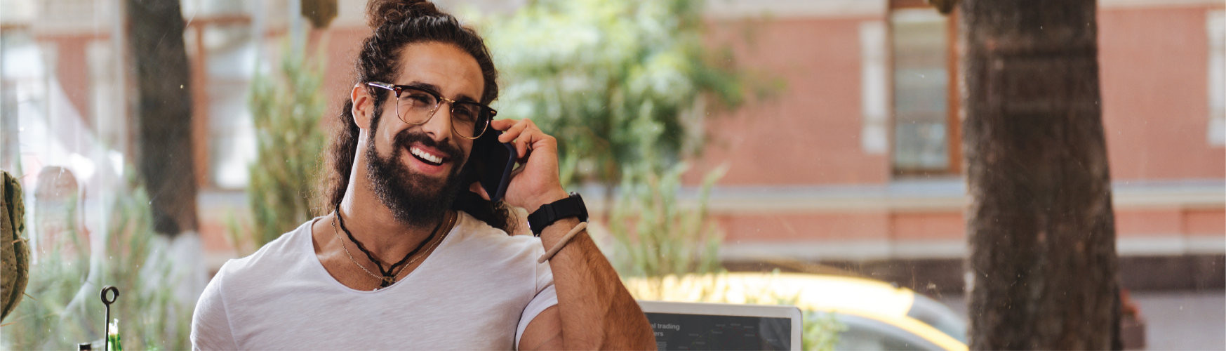 Latino man speaking on a phone.